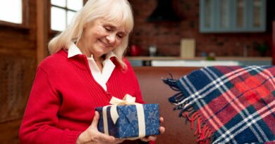 Starsza Pani trzyma w rękach zapakowany prezent